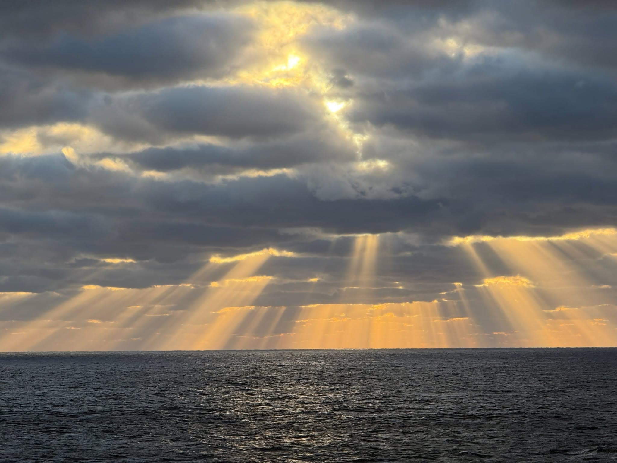Sunrays breaking through the clouds over the sea